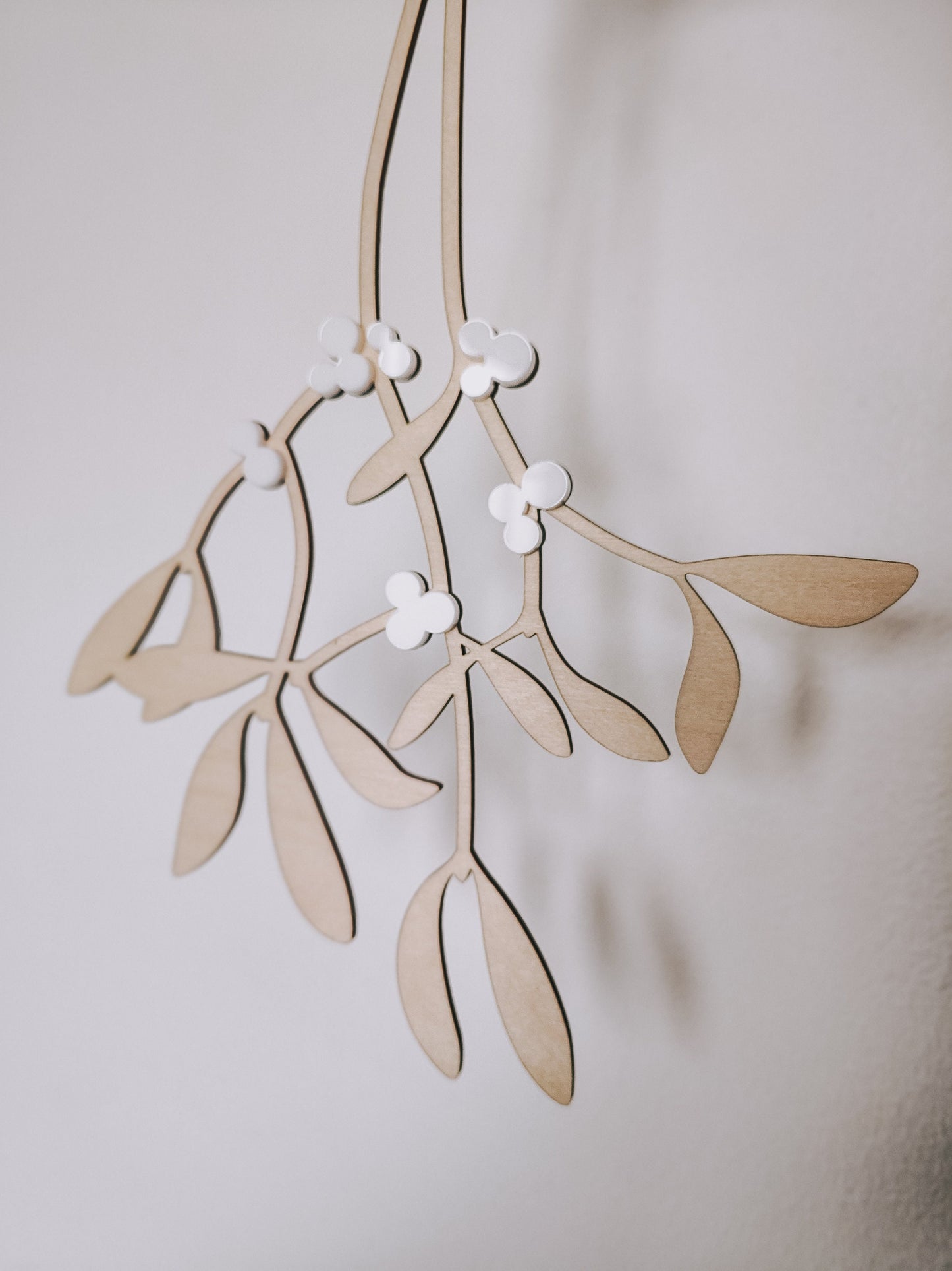 Hanging wooden mistletoe sprig