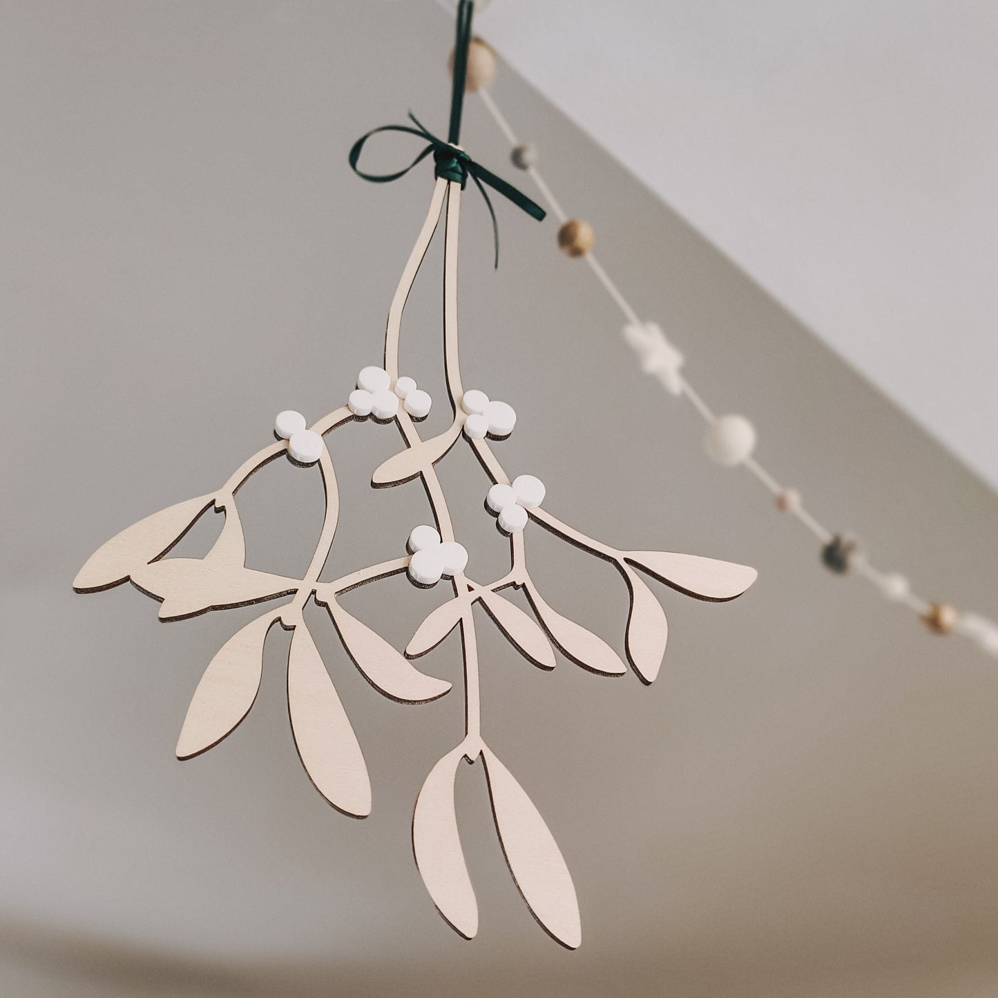 Hanging wooden mistletoe sprig