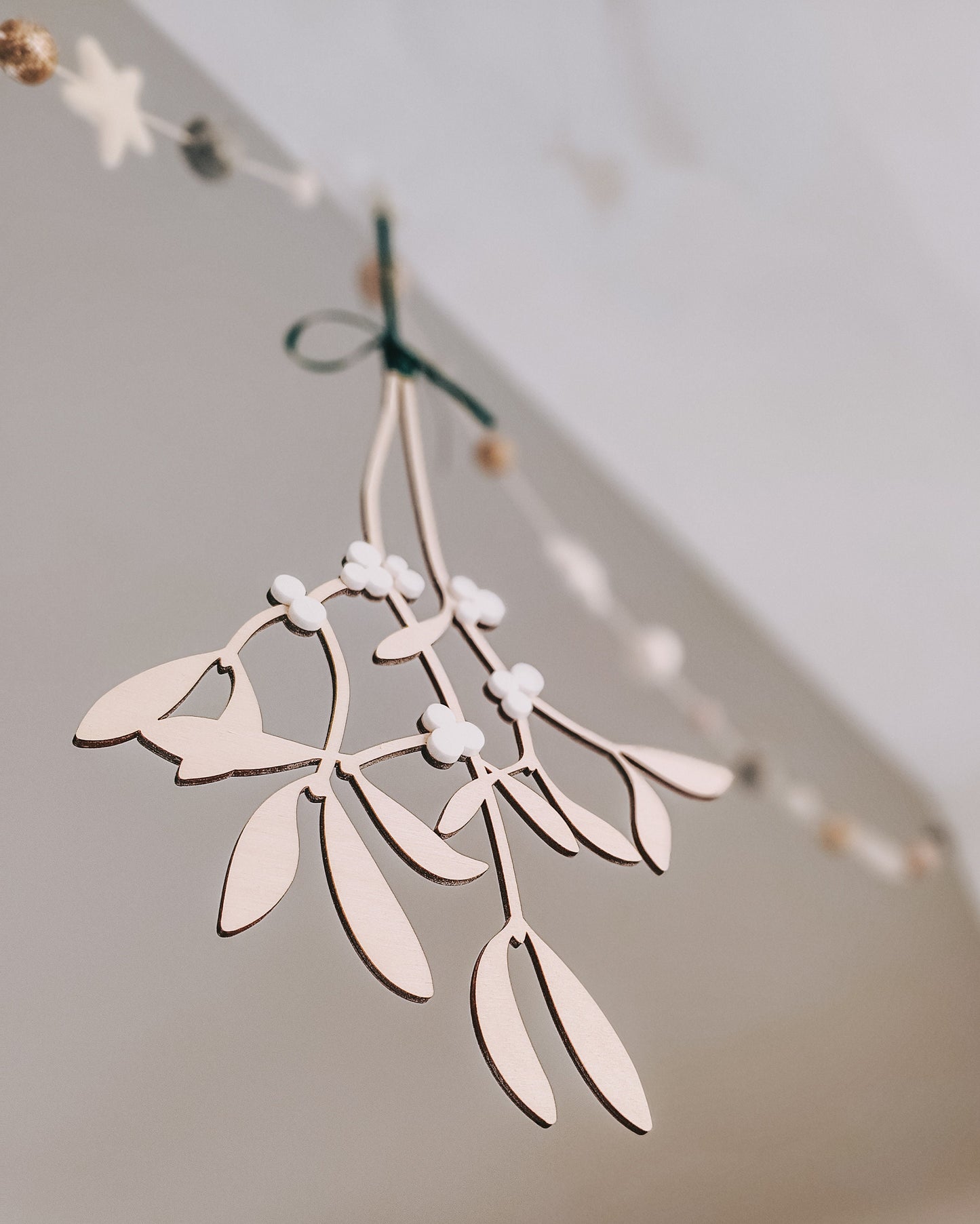 Hanging wooden mistletoe sprig