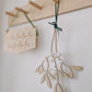 Hanging wooden mistletoe sprig