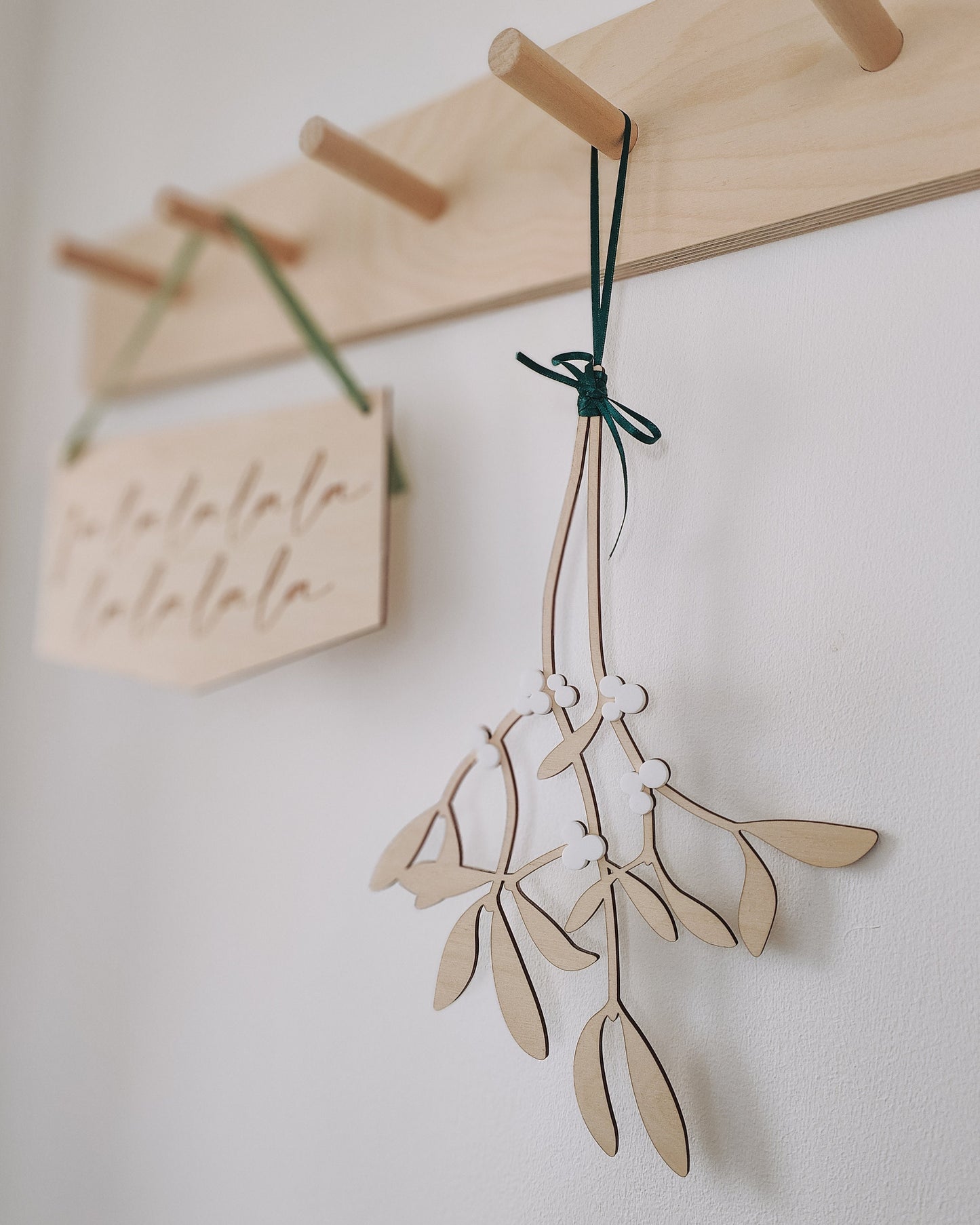 Hanging wooden mistletoe sprig